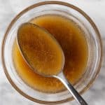 A spoonful of Citrus Balsamic Vinaigrette salad dressing in a small glass bowl.