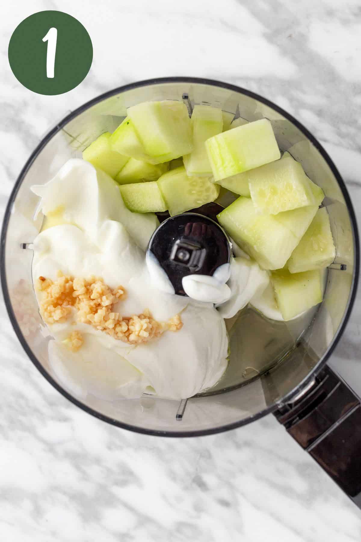 The salad dressing ingredients in a food processor.