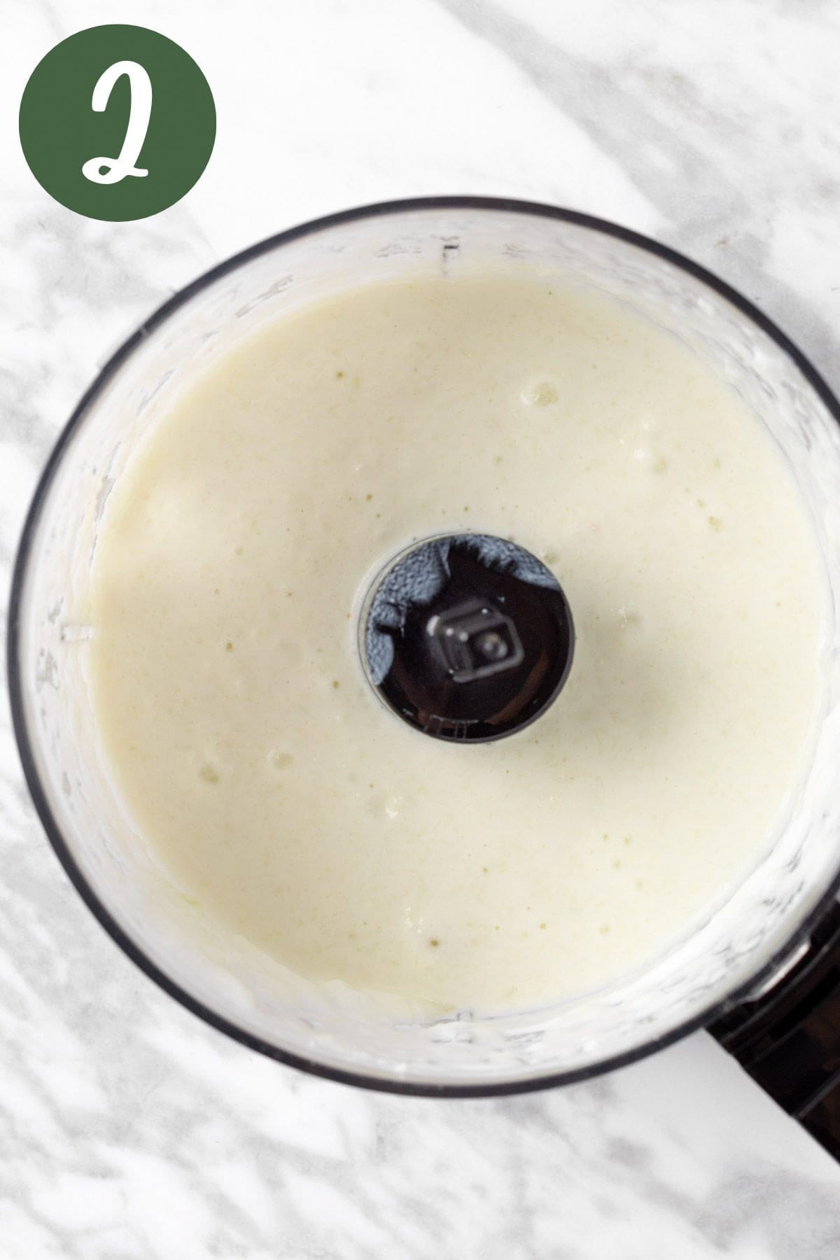 A food processor with the blended dressing.