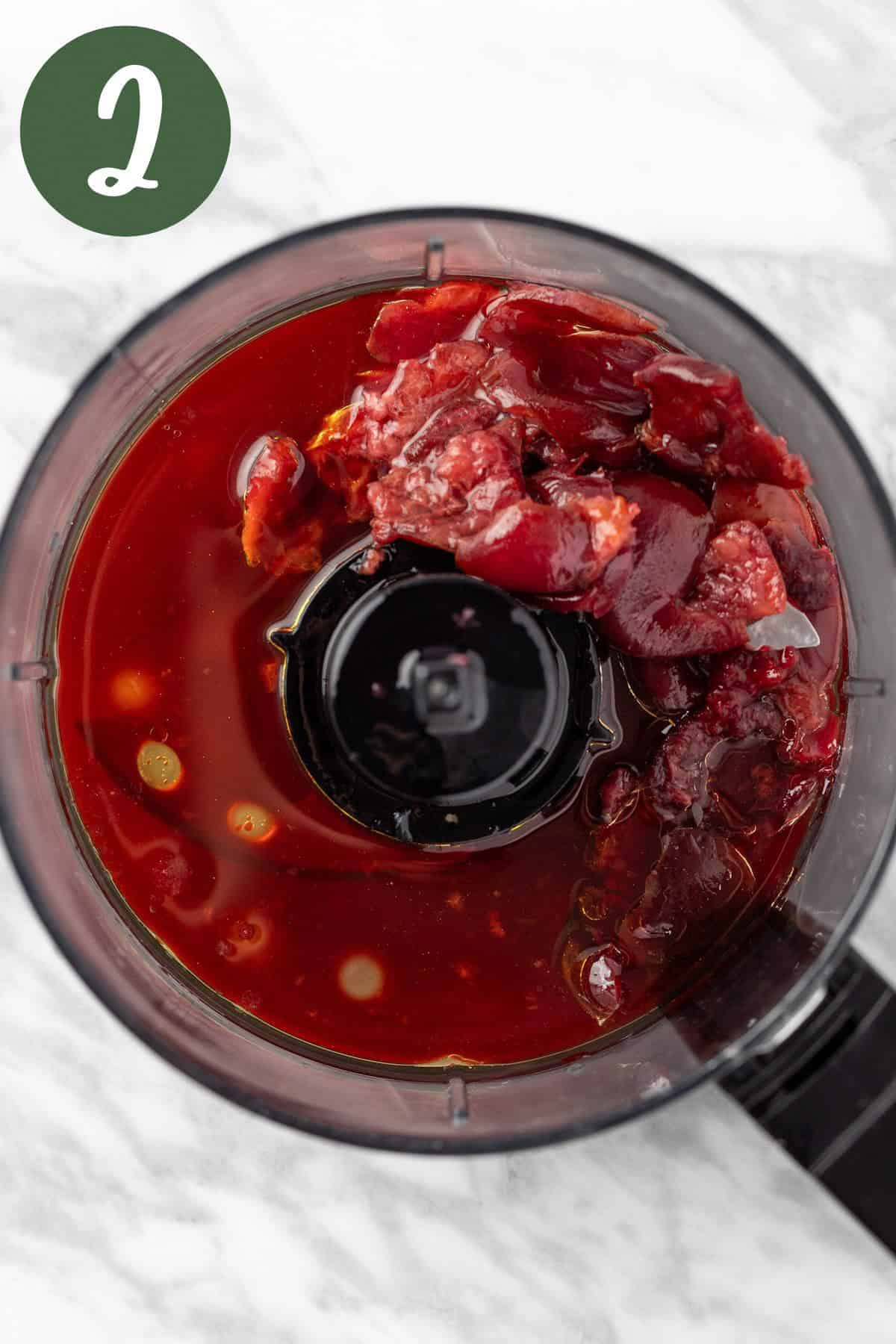 The salad dressing ingredients in a food processors, before being blended.