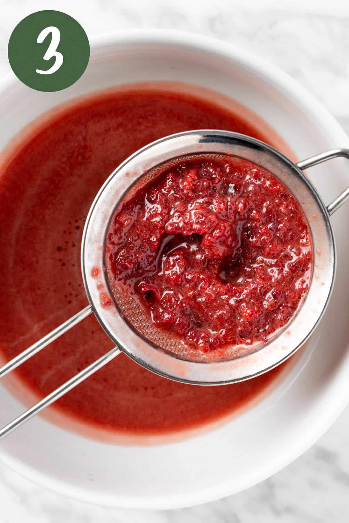 Straining out the chunks of cherries from the dressing.