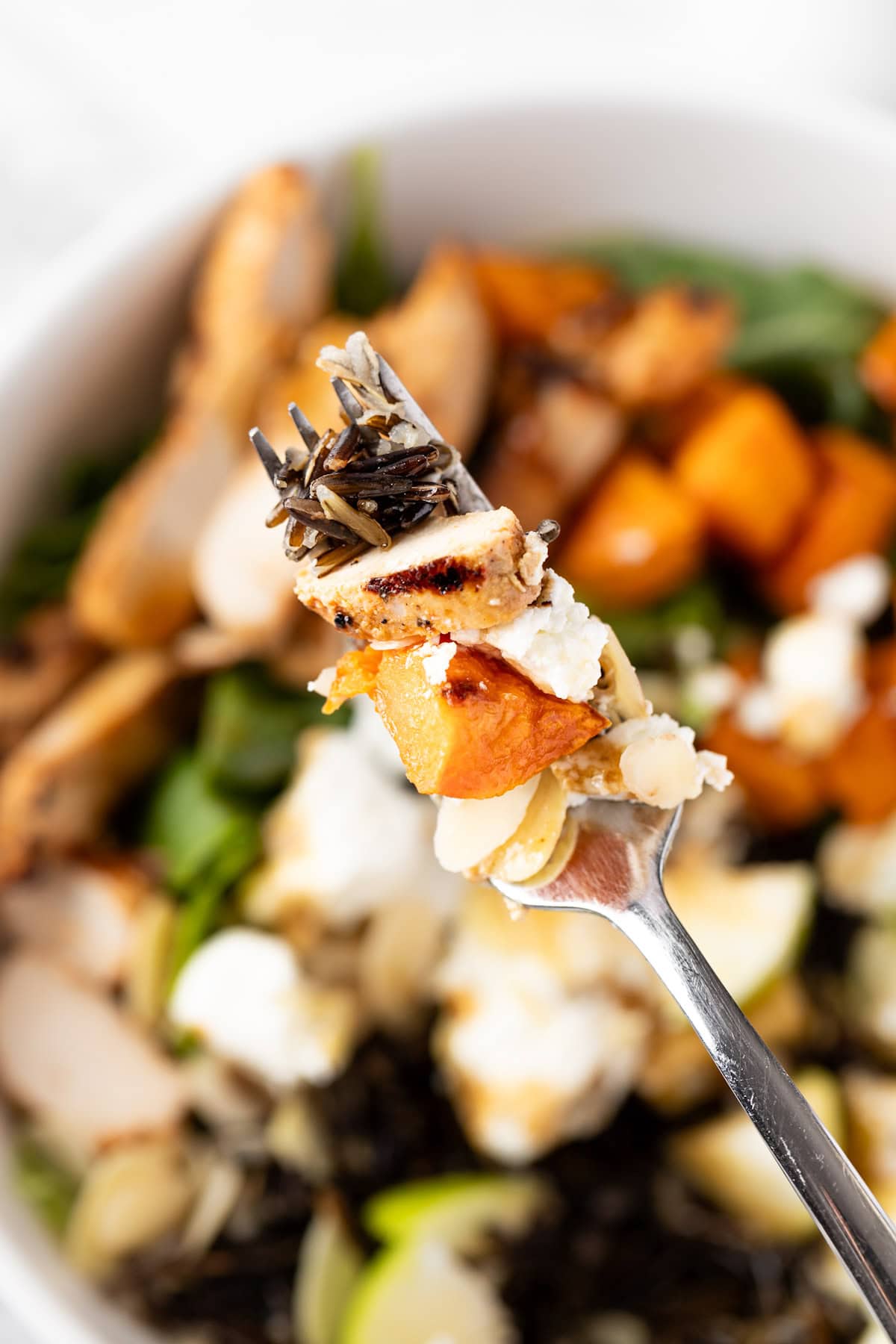 An up close photo of a forkful of Sweetgreen’s Harvest Bowl salad.