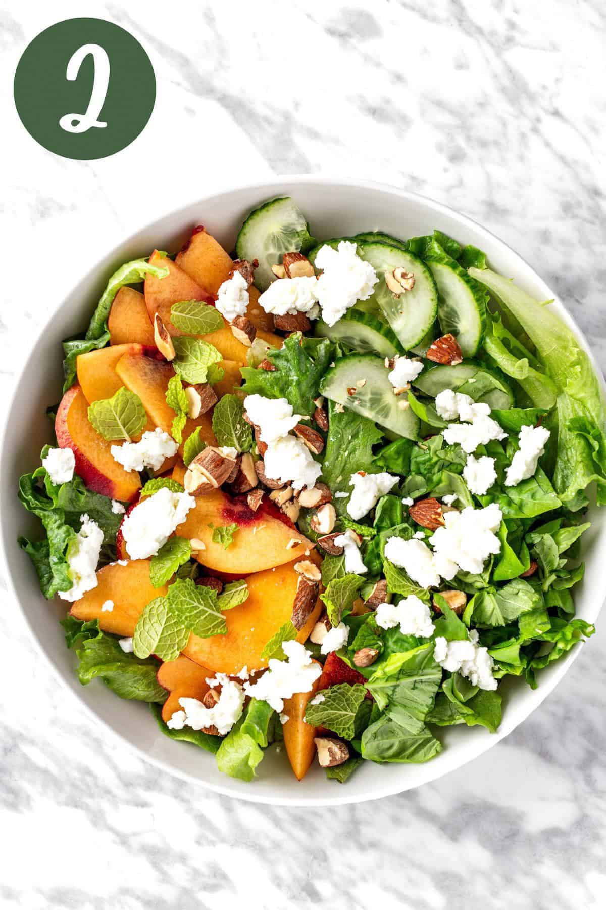 All of the salad ingredients mixed together in a salad bowl.