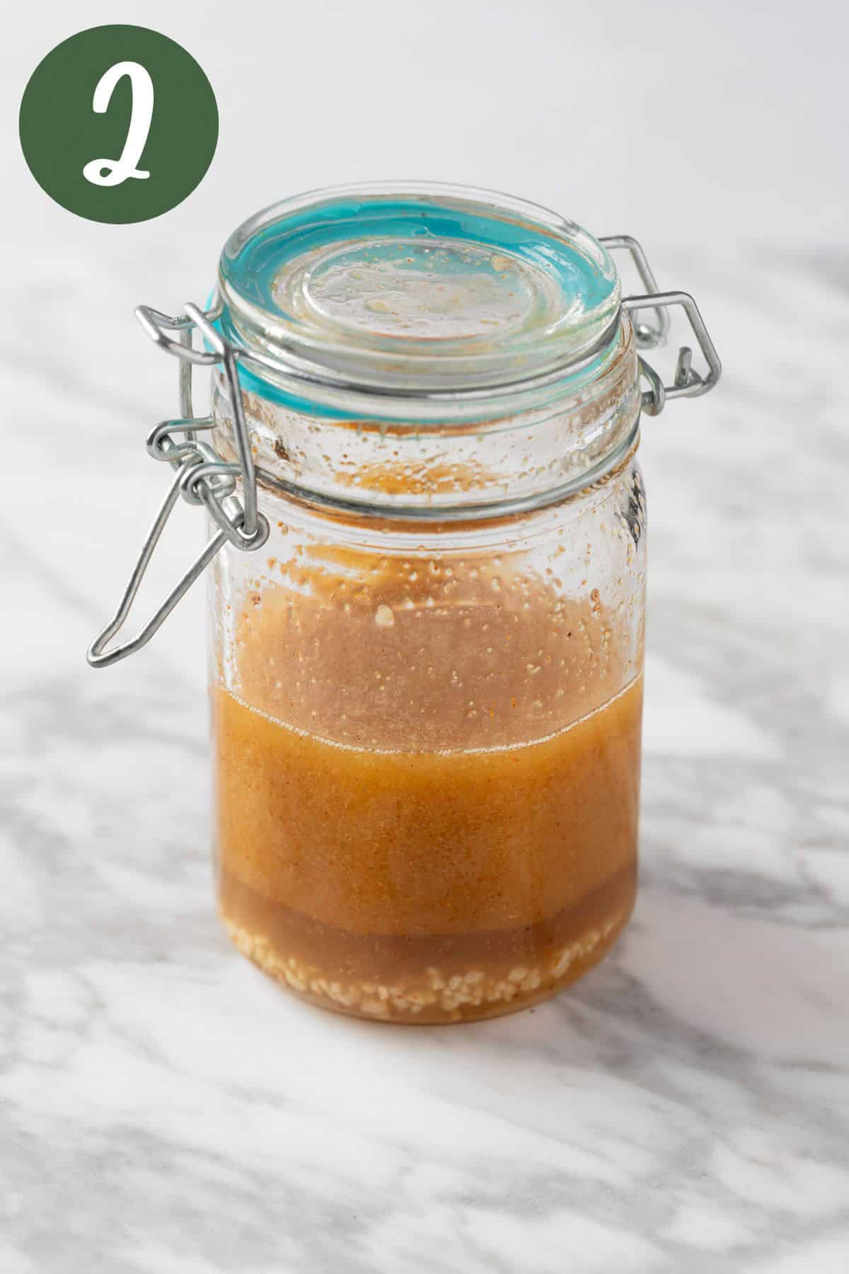 A mason jar of lime chili vinaigrette after having been shaken together.