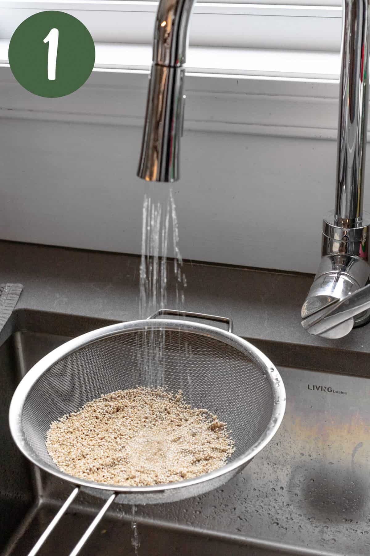 Rinsing the quinoa under cold water in a fine mesh sieve.