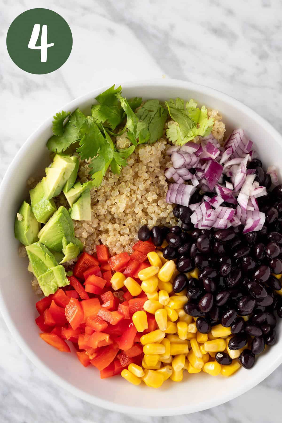 A process photo illustrating adding all the salad ingredients to a large bowl.
