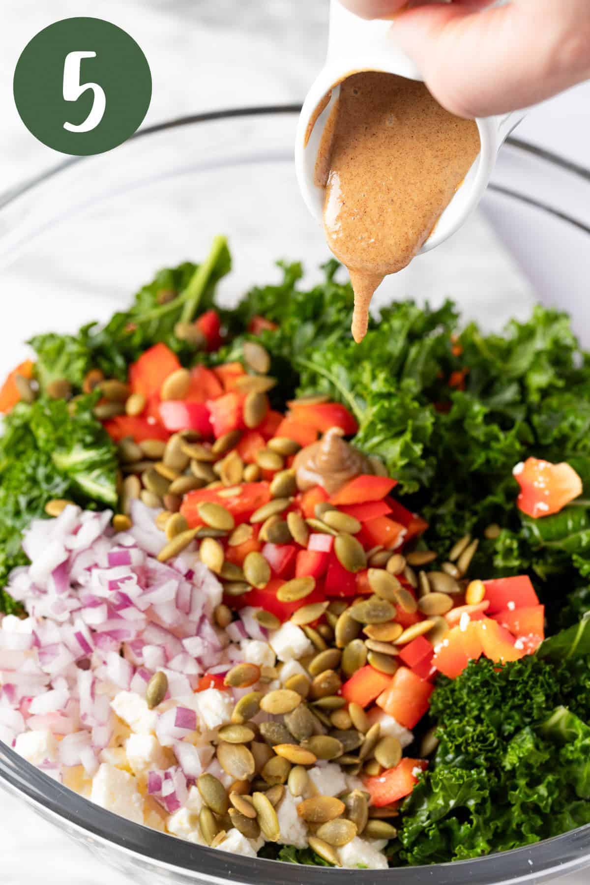 Pouring the date vinaigrette over top of the quinoa salad.
