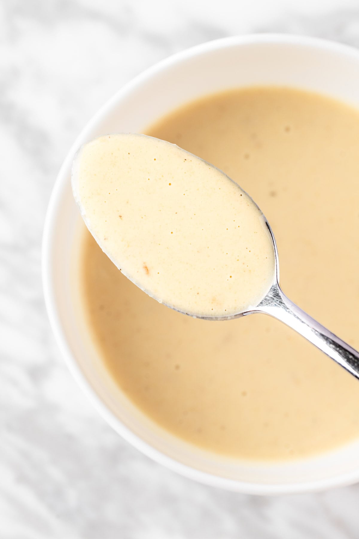 A spoonful of lemon tahini salad dressing.