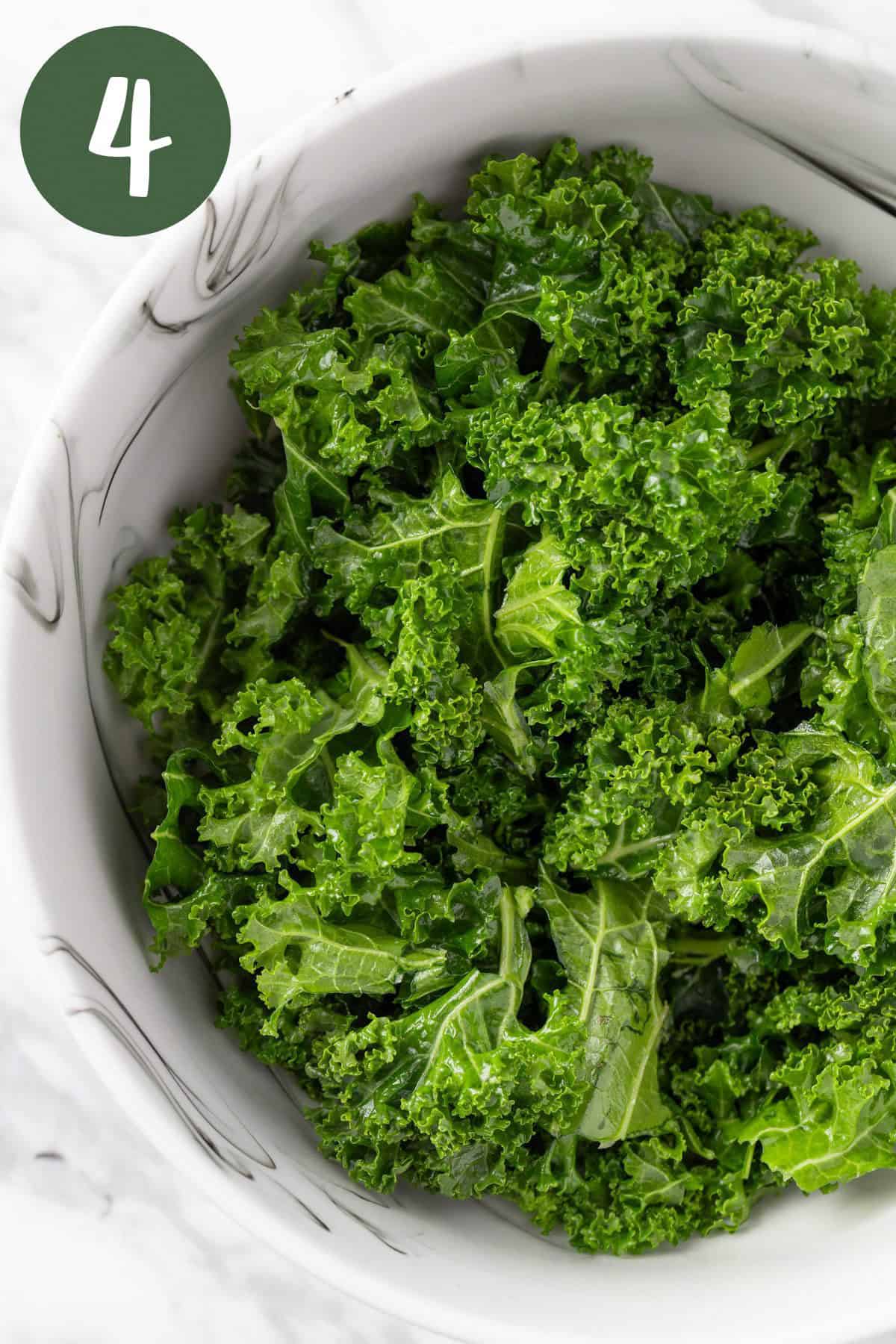 A bowl of massaged vibrant green kale.