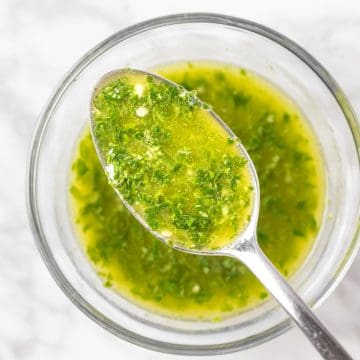 An up close spoonful of Sweetgreen pesto vinaigrette made with fresh basil and olive oil.