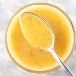 An up close spoonful of apple cider and dijon mustard vinaigrette.