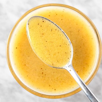 An up close spoonful of apple cider and dijon mustard vinaigrette.