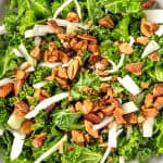 Overhead view of a bowl of Chick-Fil-A Kale Crunch salad made withe kale, roasted almonds, green cabbage and topped with an apple cider dijon vinaigrette.