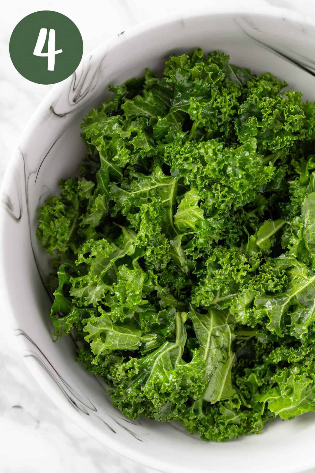 A process photo of massaged, vibrant green kale.