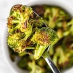 An up-close view of a spoonful of roasted Sweetgreen spicy broccoli.