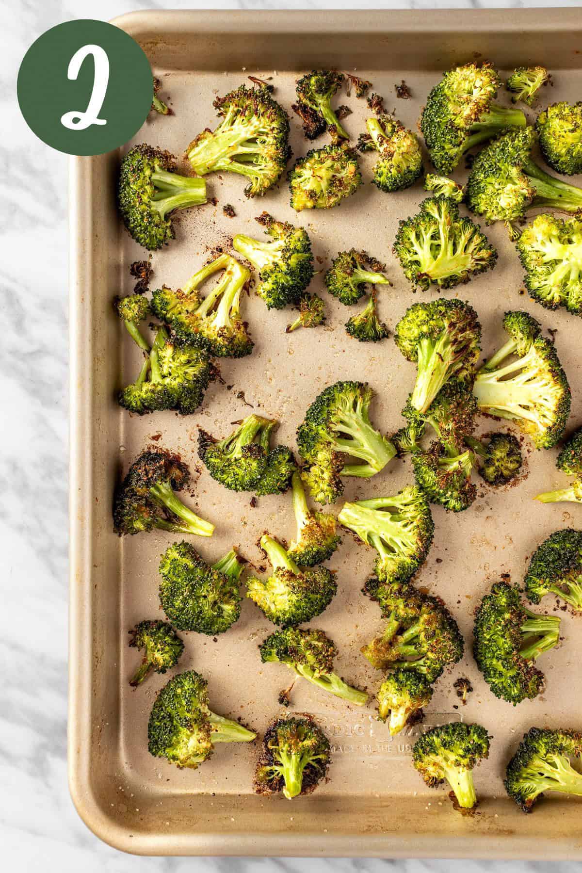A process photo of the spicy umami seasoning broccoli on a baking tray, fresh out of the oven.