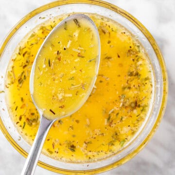 An overhead view of a spoonful of Panera Greek Salad Dressing.