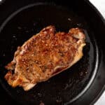 Steak for steak salad on a cast iron skillet.