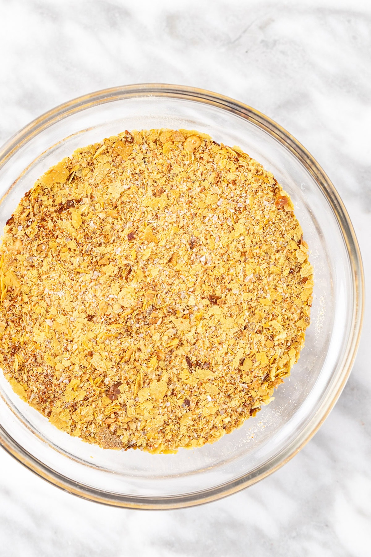 Up close view of umami seasoning in a small glass bowl.